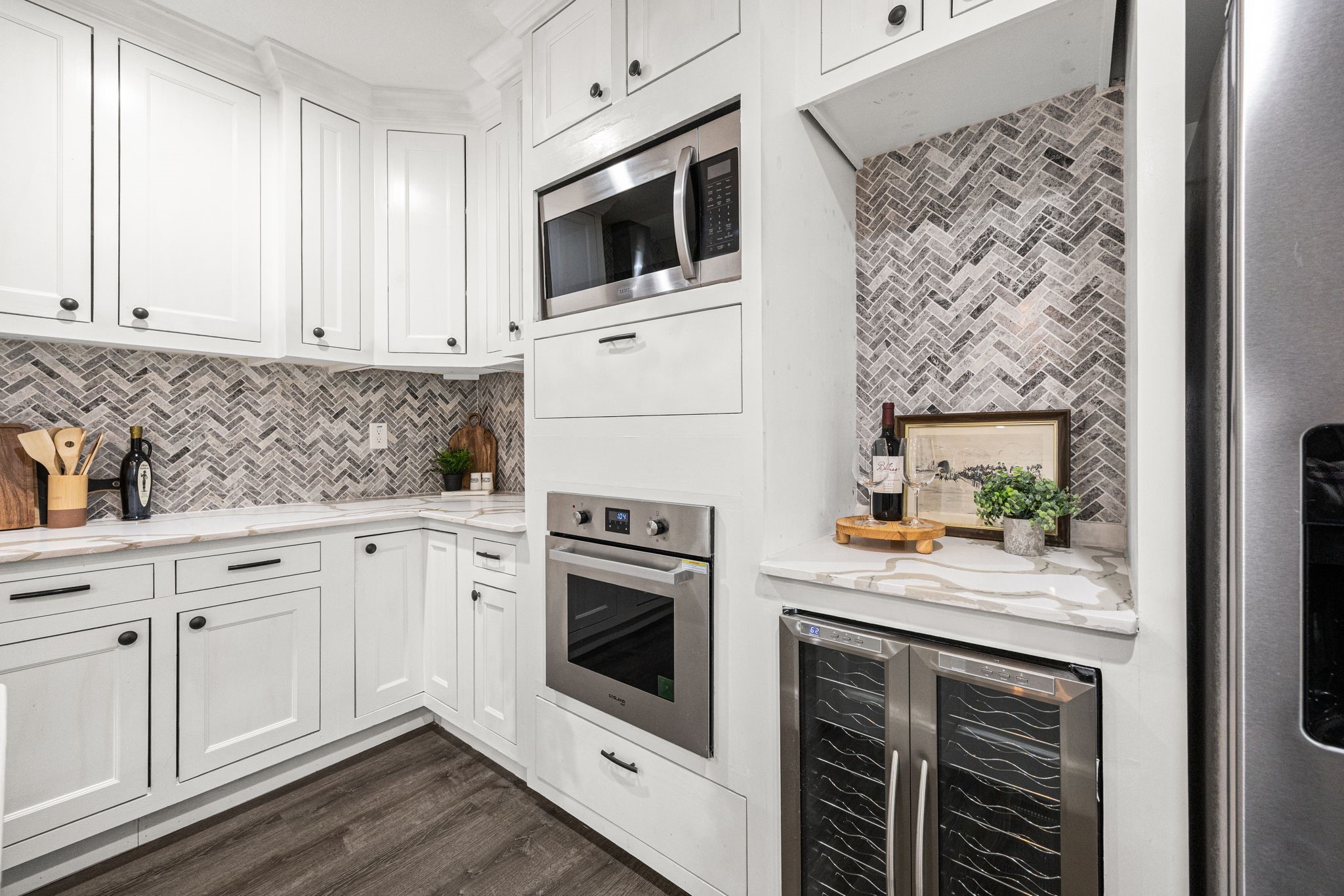 1405 Walton Street Houston, TX 77009 - Photo 9 of 28 Custom beverage nook with dual wine refrigerator and generous counter space ideal for a bar display, espresso station, or serving area. Surrounded by designer tile and seamless cabinetry for a polished, built-in feel.