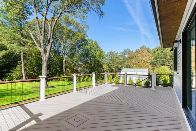 a view of a deck with a big yard next to a yard