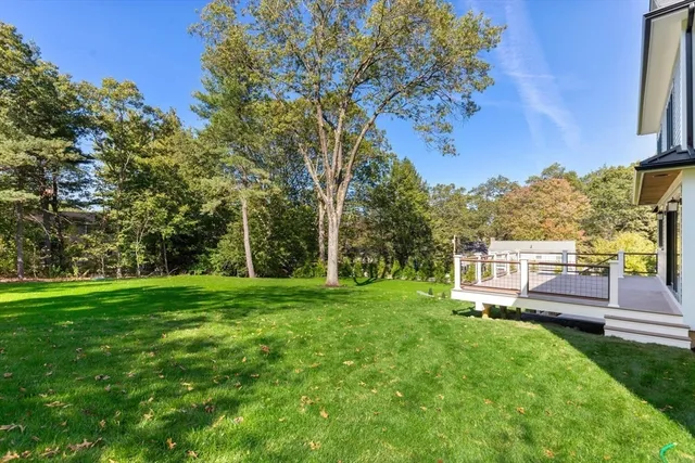 a view of a green field with wooden fence