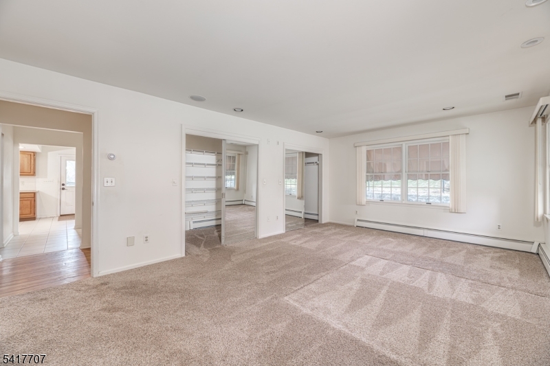23 Old Denville Road Boonton, NJ 07005 - Photo 13 of 50 a view of an empty room with a window and wooden floor