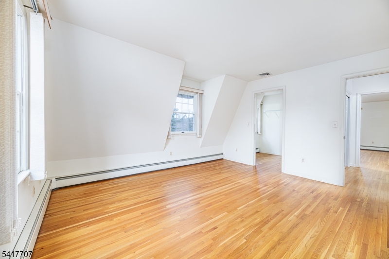 23 Old Denville Road Boonton, NJ 07005 - Photo 19 of 50 a view of empty room with wooden floor and fan