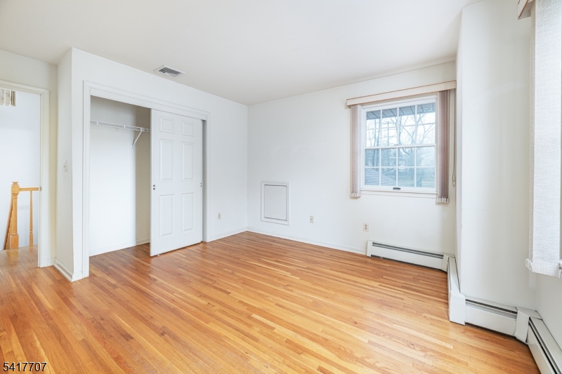 23 Old Denville Road Boonton, NJ 07005 - Photo 21 of 50 a view of empty room with wooden floor and fan