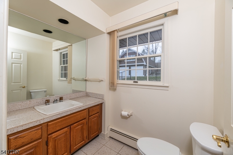 23 Old Denville Road Boonton, NJ 07005 - Photo 24 of 50 a bathroom with a granite countertop toilet sink and mirror