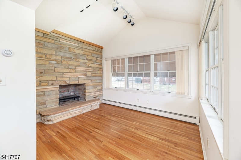 23 Old Denville Road Boonton, NJ 07005 - Photo 29 of 50 a view of an empty room with wooden floor and a window
