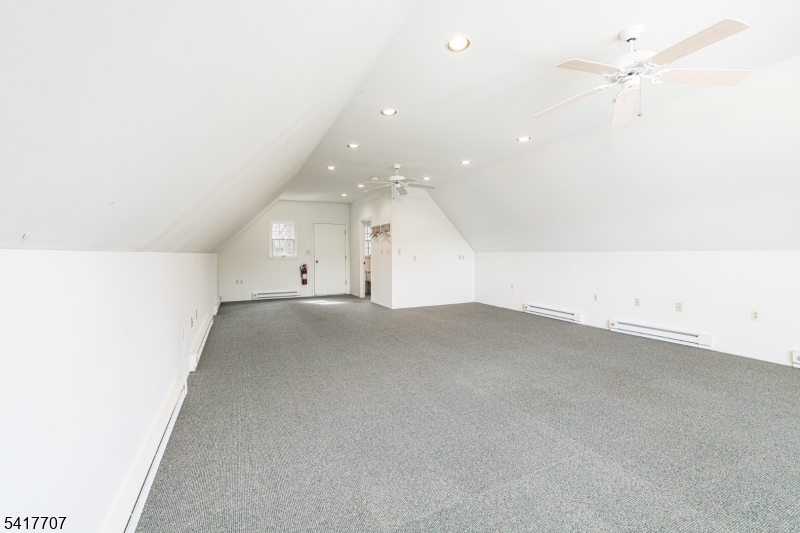 23 Old Denville Road Boonton, NJ 07005 - Photo 31 of 50 an empty room with a bathroom and a ceiling fan