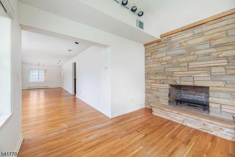 23 Old Denville Road Boonton, NJ 07005 - Photo 8 of 50 a view of empty room with wooden floor and fire place
