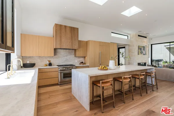 a large kitchen with a table and chairs in it