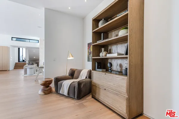 a bedroom with furniture and a book shelf