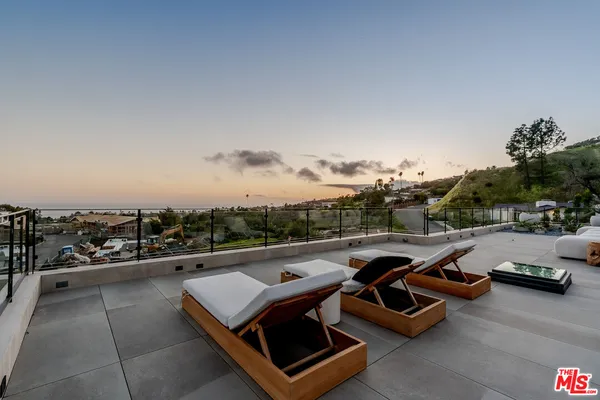 a view of a terrace with couches and sky view