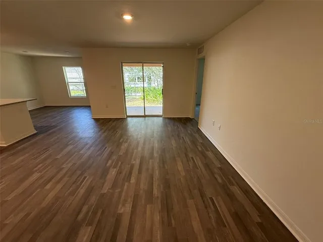 a view of wooden floor and windows in a room