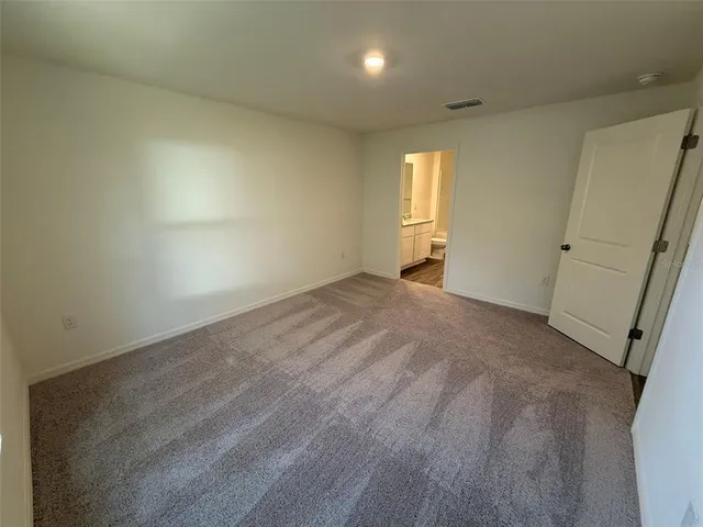 en empty room with windows and cabinet