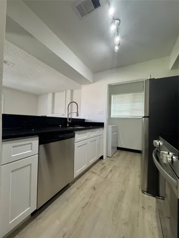 a kitchen with a sink and cabinets