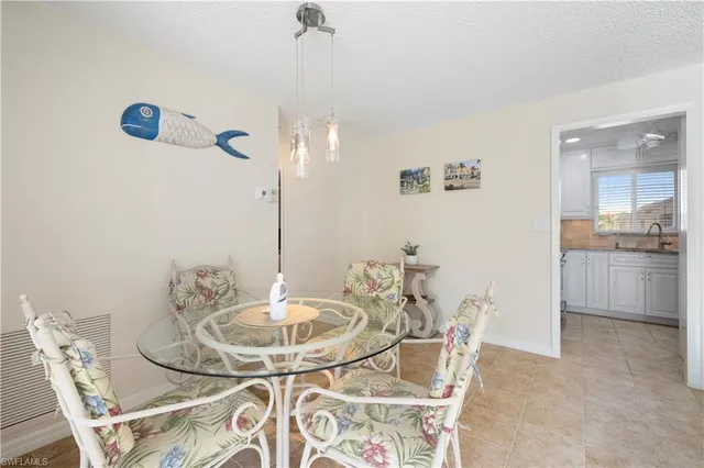 a dining room with furniture and a chandelier