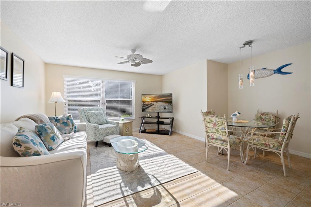 578 Broad Avenue South, Unit 578 Naples, FL 34102 - Photo 14 of 32 a living room with furniture and a large window