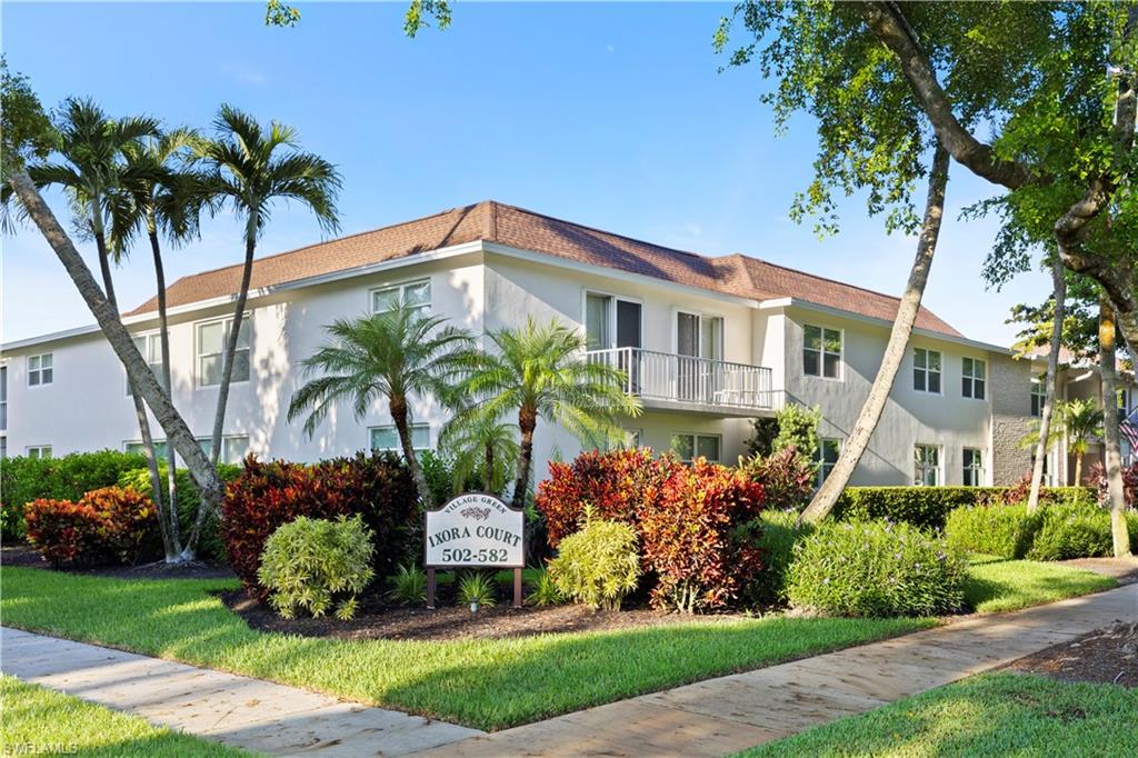 578 Broad Avenue South, Unit 578 Naples, FL 34102 - Photo 2 of 32 a front view of a house with a garden