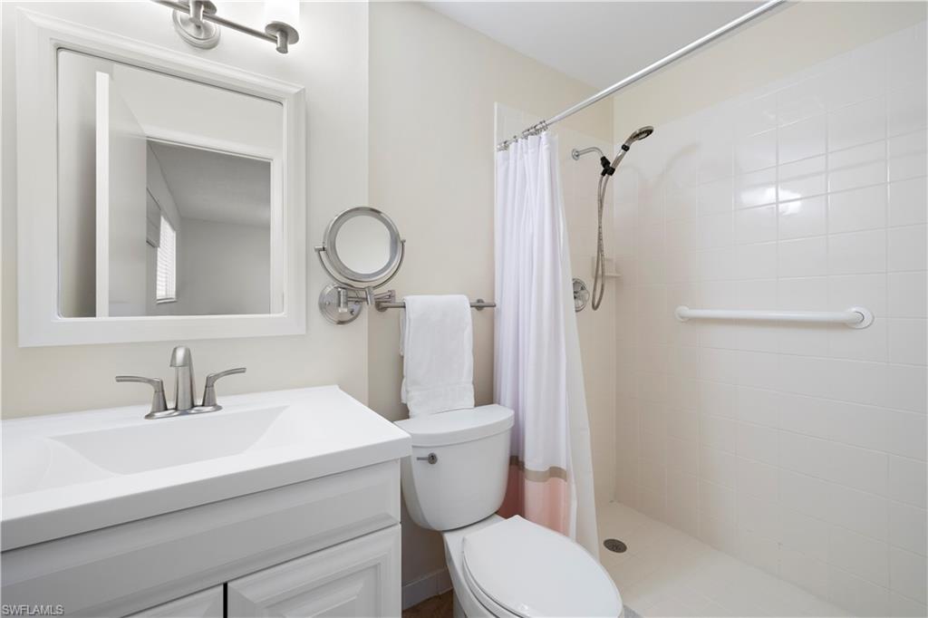 578 Broad Avenue South, Unit 578 Naples, FL 34102 - Photo 22 of 32 a bathroom with a sink toilet and shower