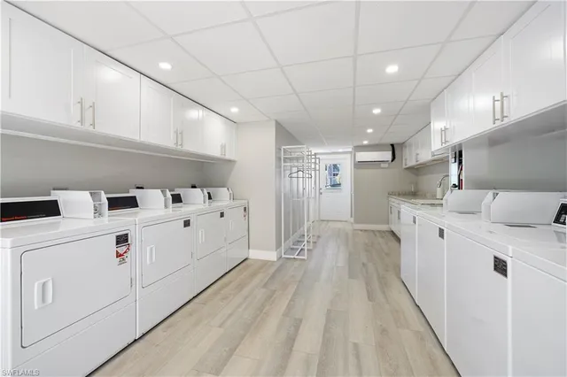 a view of washer and dryer with wooden floors