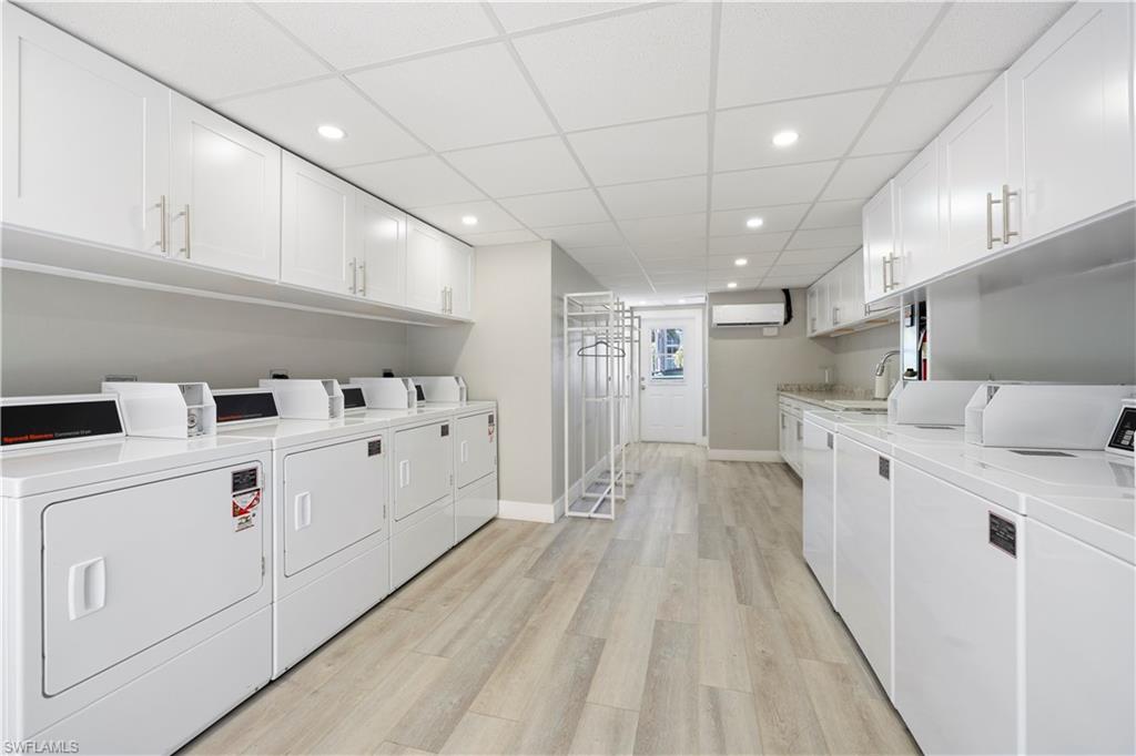 578 Broad Avenue South, Unit 578 Naples, FL 34102 - Photo 23 of 32 a view of washer and dryer with wooden floors