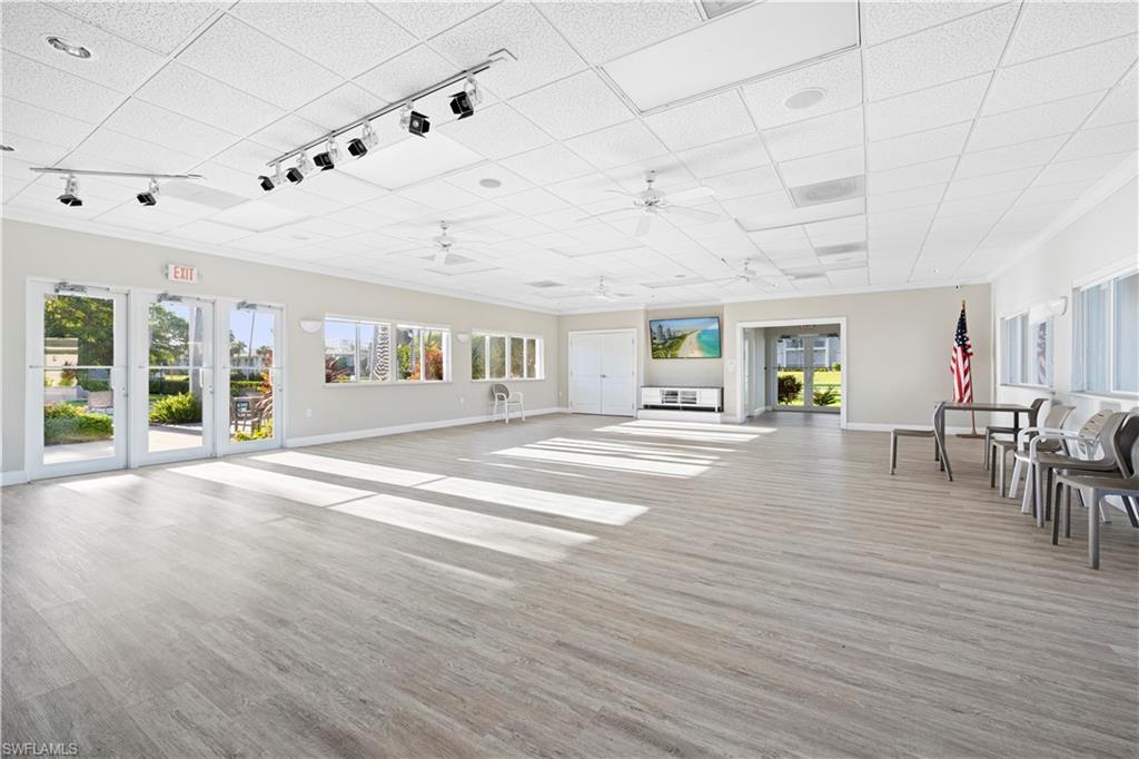 578 Broad Avenue South, Unit 578 Naples, FL 34102 - Photo 24 of 32 a view of an empty room with window and wooden floor