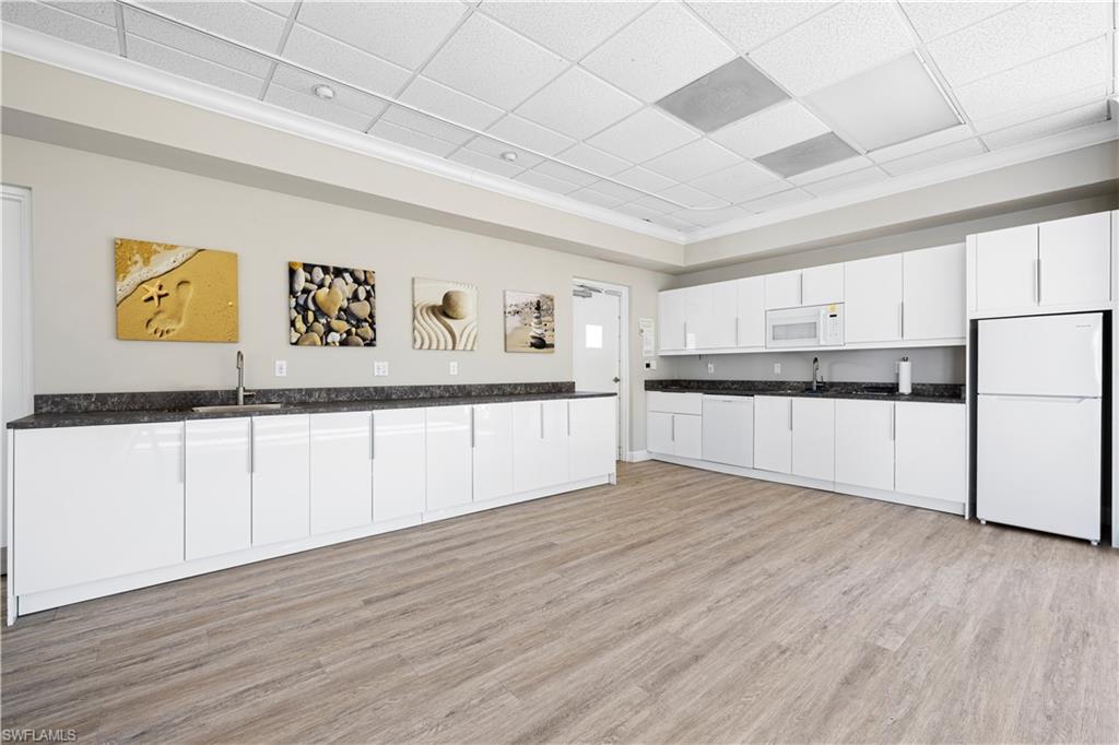 578 Broad Avenue South, Unit 578 Naples, FL 34102 - Photo 25 of 32 a view of a kitchen with wooden floor