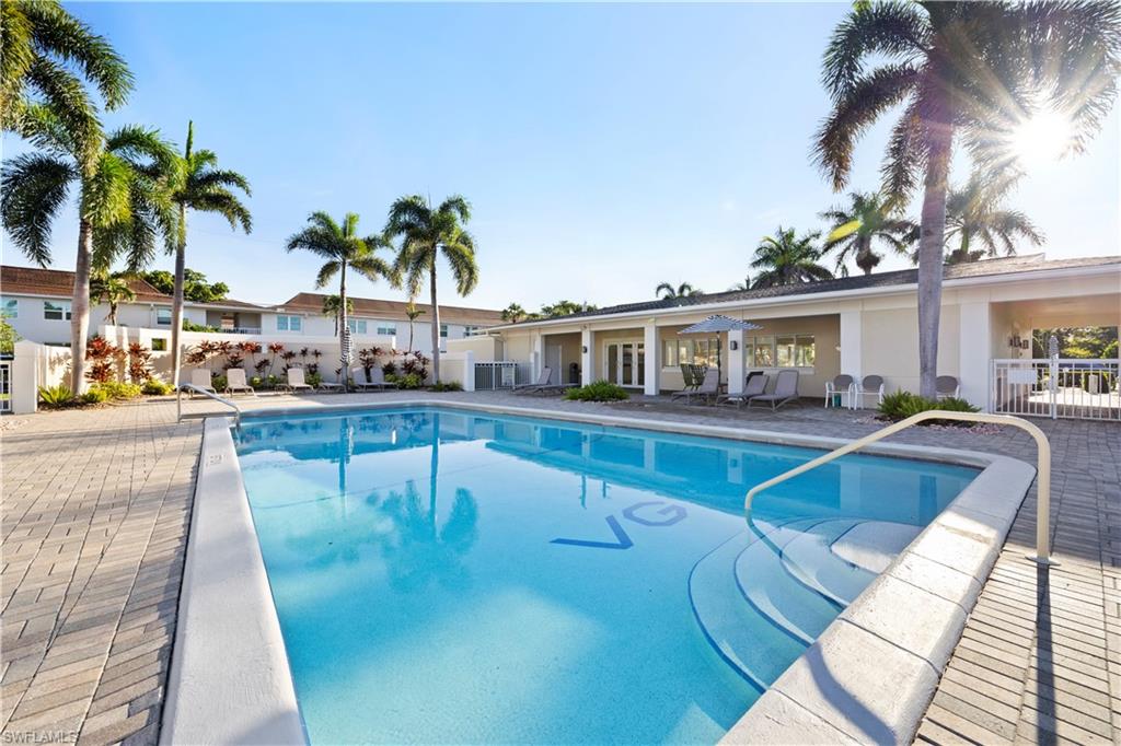 578 Broad Avenue South, Unit 578 Naples, FL 34102 - Photo 27 of 32 a view of a swimming pool with a patio