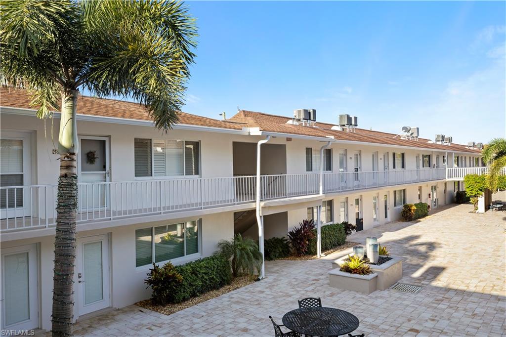 578 Broad Avenue South, Unit 578 Naples, FL 34102 - Photo 5 of 32 a front view of a building with street view