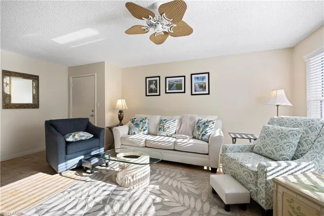 a living room with furniture and a rug
