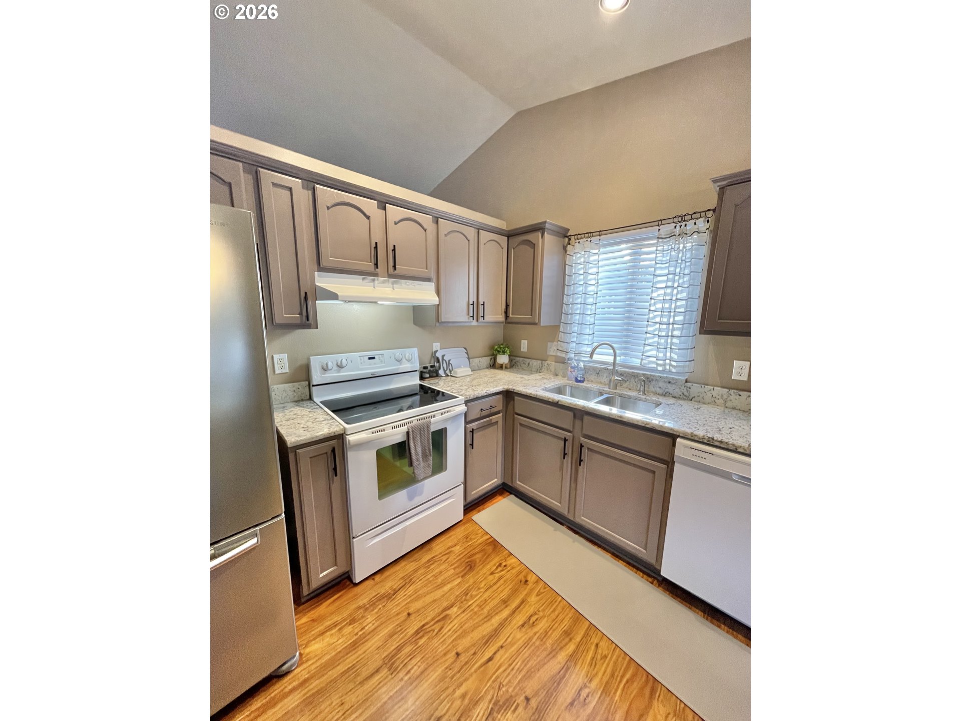 135 Wander Way Southeast Salem, OR 97301 - Photo 11 of 36 a kitchen with granite countertop white cabinets and white appliances