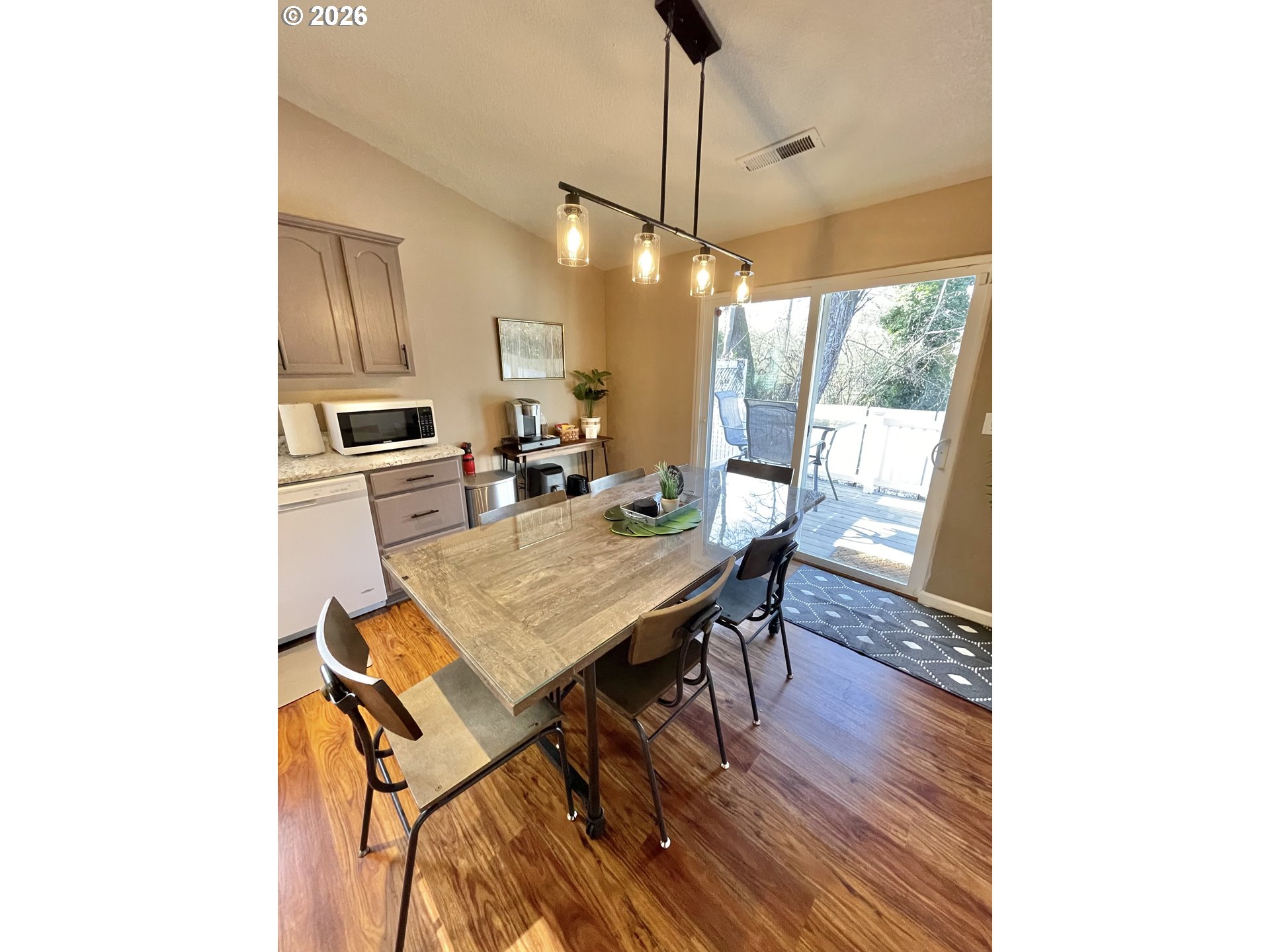 135 Wander Way Southeast Salem, OR 97301 - Photo 12 of 36 a kitchen with a table chairs and wooden floor