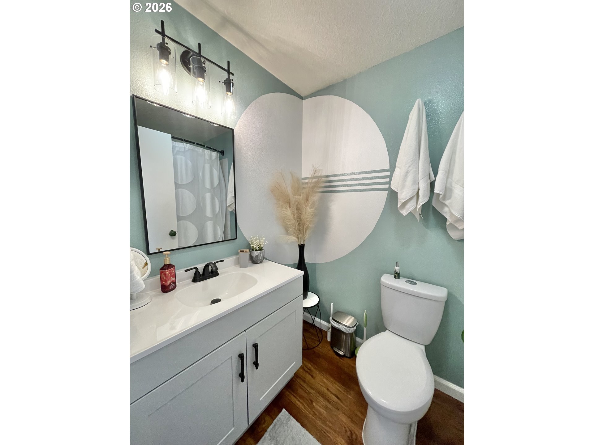 135 Wander Way Southeast Salem, OR 97301 - Photo 16 of 36 a bathroom with a sink mirror vanity and toilet
