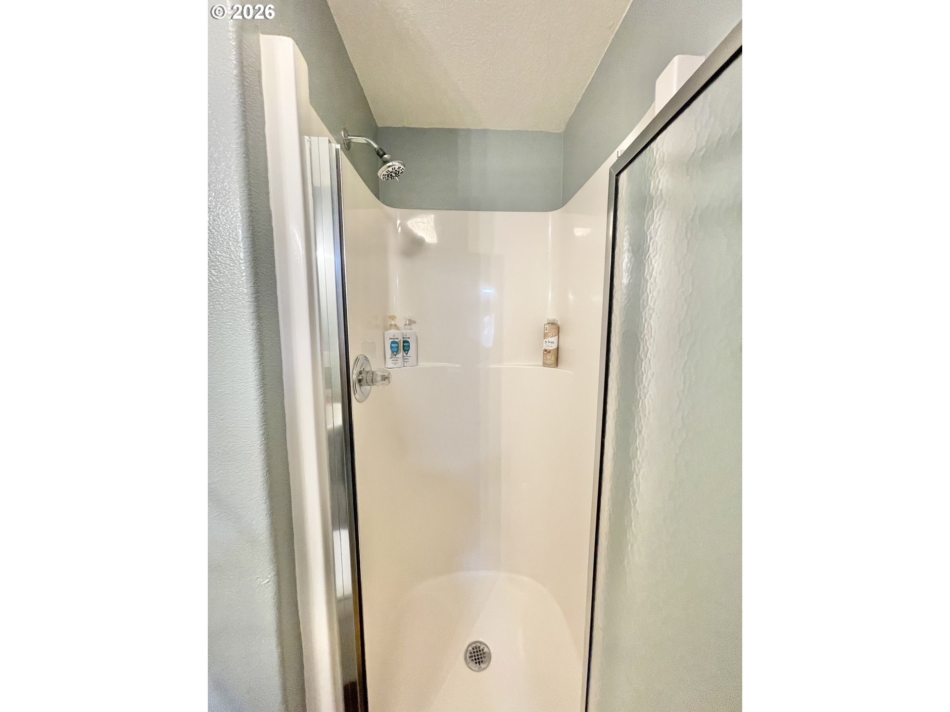 135 Wander Way Southeast Salem, OR 97301 - Photo 24 of 36 a bathroom with a glass shower door