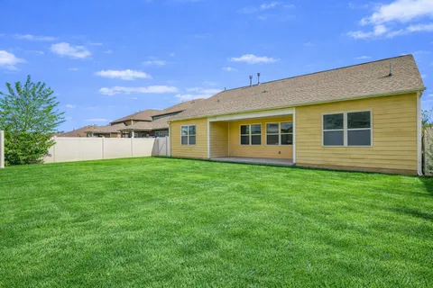 a view of a house with a backyard