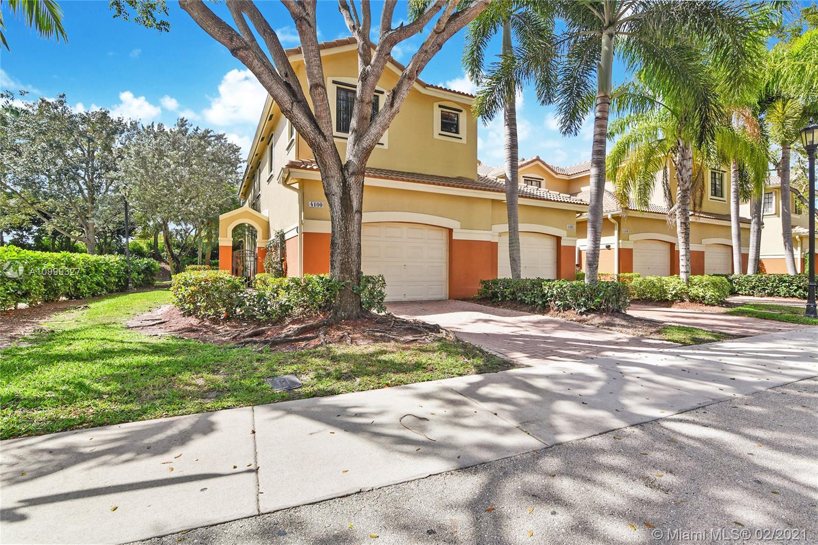 4100 Forest Drive, Unit 4100 Weston, FL 33332 - Photo 1 of 14 a front view of a house with a yard and trees