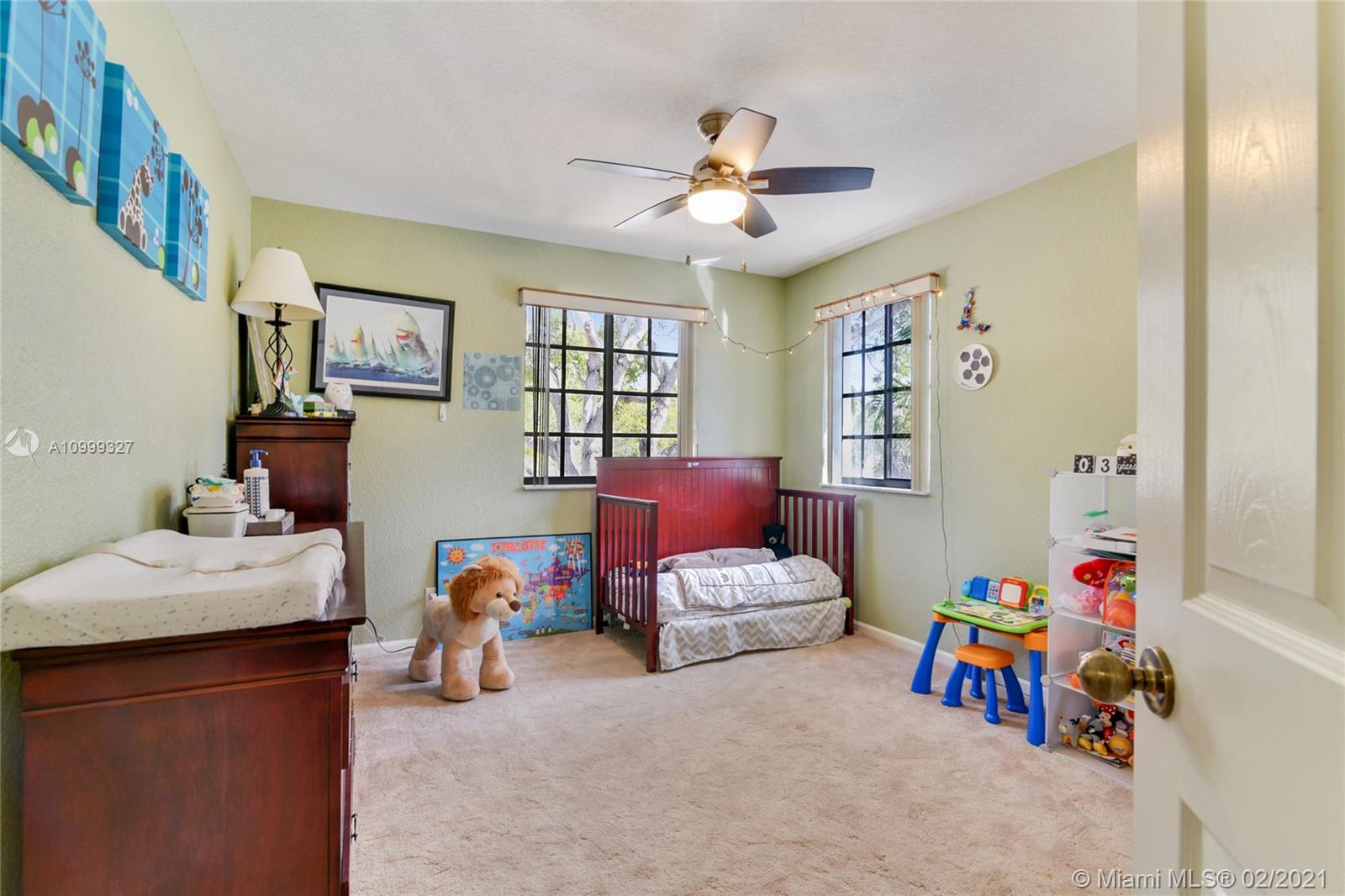 4100 Forest Drive, Unit 4100 Weston, FL 33332 - Photo 12 of 14 a bedroom with bed and a chandelier