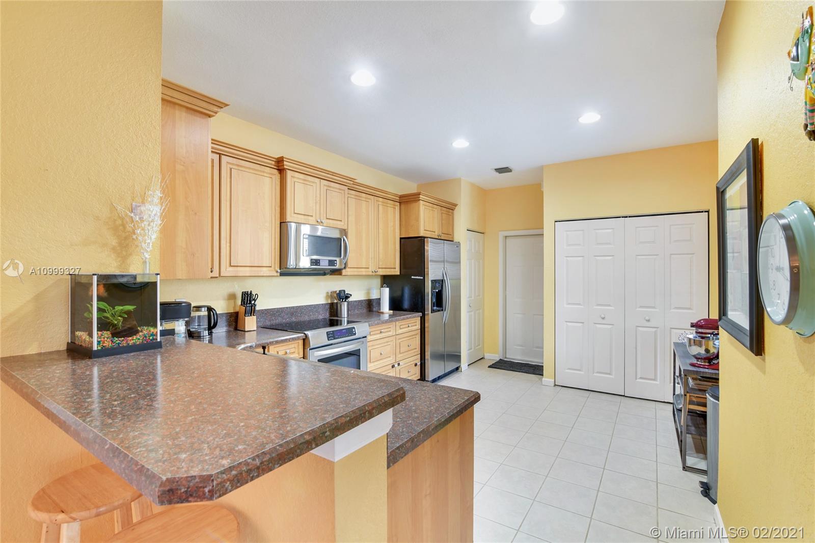 4100 Forest Drive, Unit 4100 Weston, FL 33332 - Photo 6 of 14 a kitchen with sink refrigerator and window
