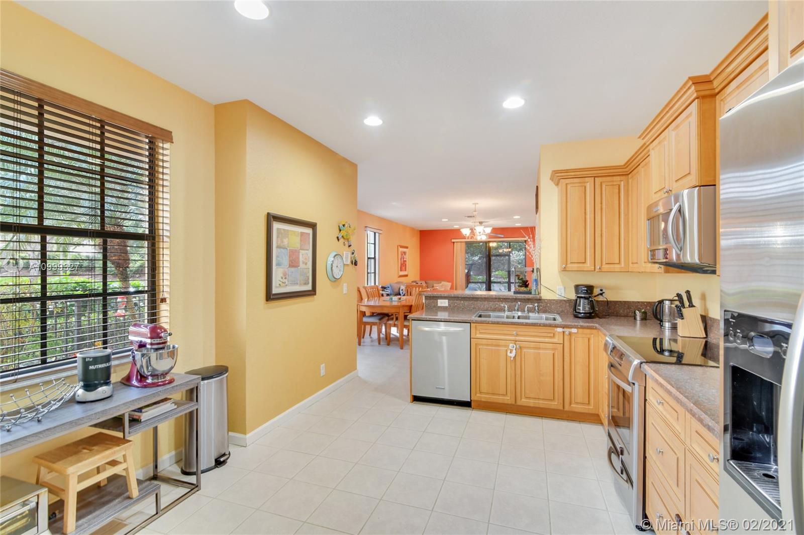 4100 Forest Drive, Unit 4100 Weston, FL 33332 - Photo 7 of 14 a kitchen with stainless steel appliances granite countertop sink stove top oven and cabinets