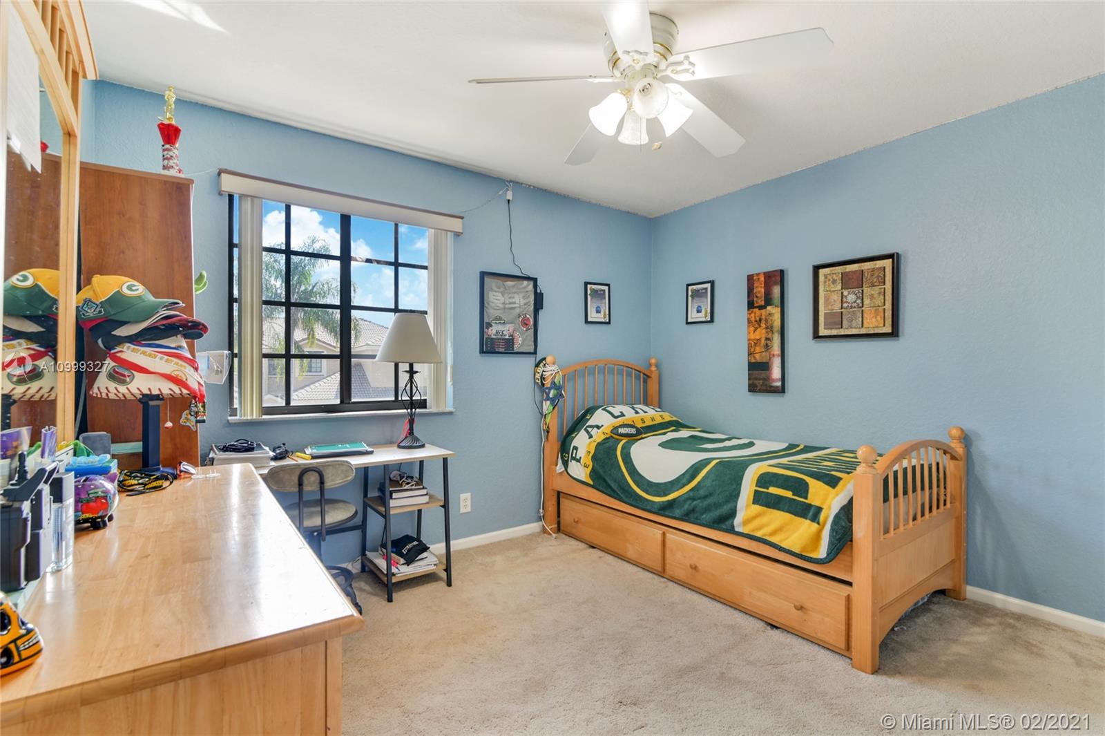 4100 Forest Drive, Unit 4100 Weston, FL 33332 - Photo 10 of 14 a bedroom with a bed and a chandelier