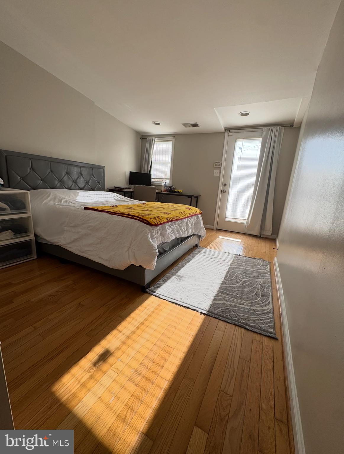 1746 South Hanover Street Baltimore, MD 21230 - Photo 12 of 19 a bedroom with a bed and wooden floor