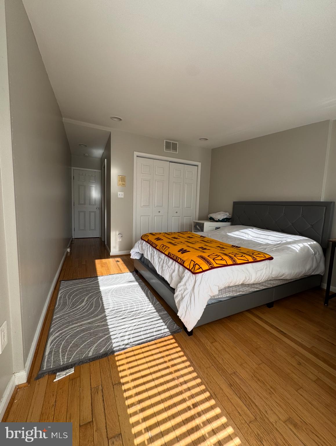 1746 South Hanover Street Baltimore, MD 21230 - Photo 13 of 19 a bedroom with a bed and wooden floor