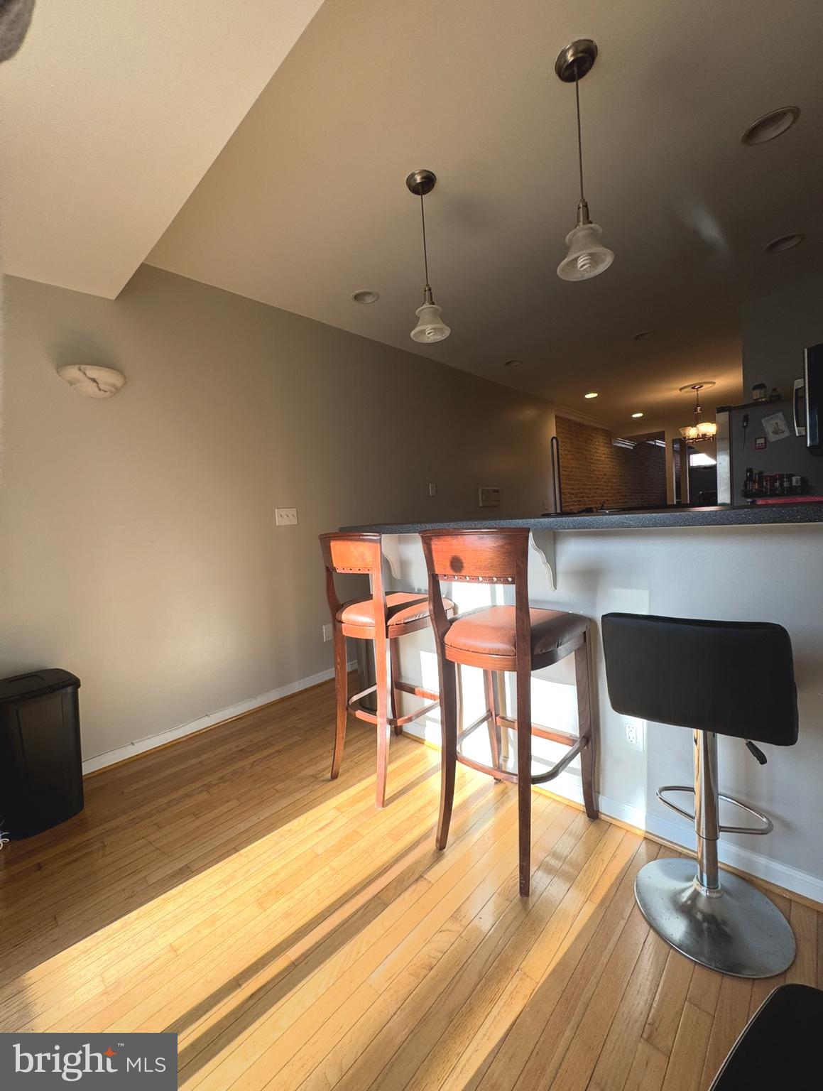 1746 South Hanover Street Baltimore, MD 21230 - Photo 2 of 19 a kitchen with a table chairs and wooden floor