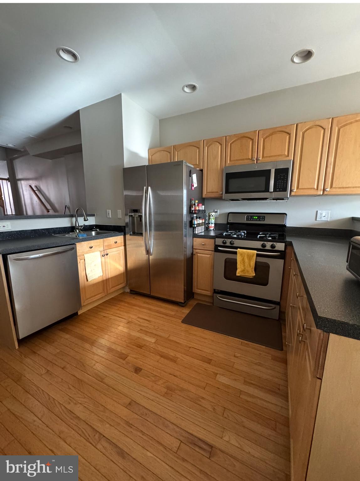 1746 South Hanover Street Baltimore, MD 21230 - Photo 4 of 19 a kitchen with stainless steel appliances granite countertop a stove a sink and a refrigerator