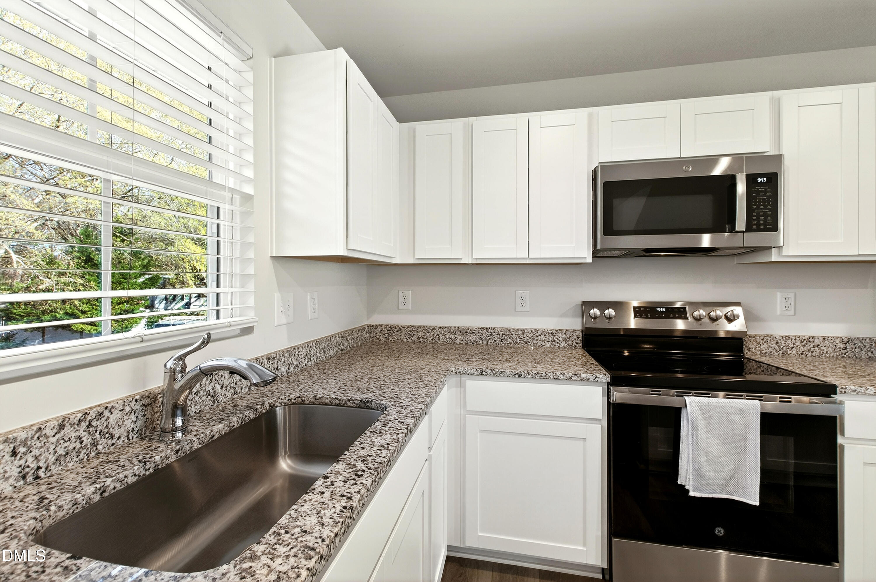 4629 Great Egret Way Raleigh, NC 27616 - Photo 13 of 48 a kitchen with stainless steel appliances granite countertop a stove a microwave and a sink