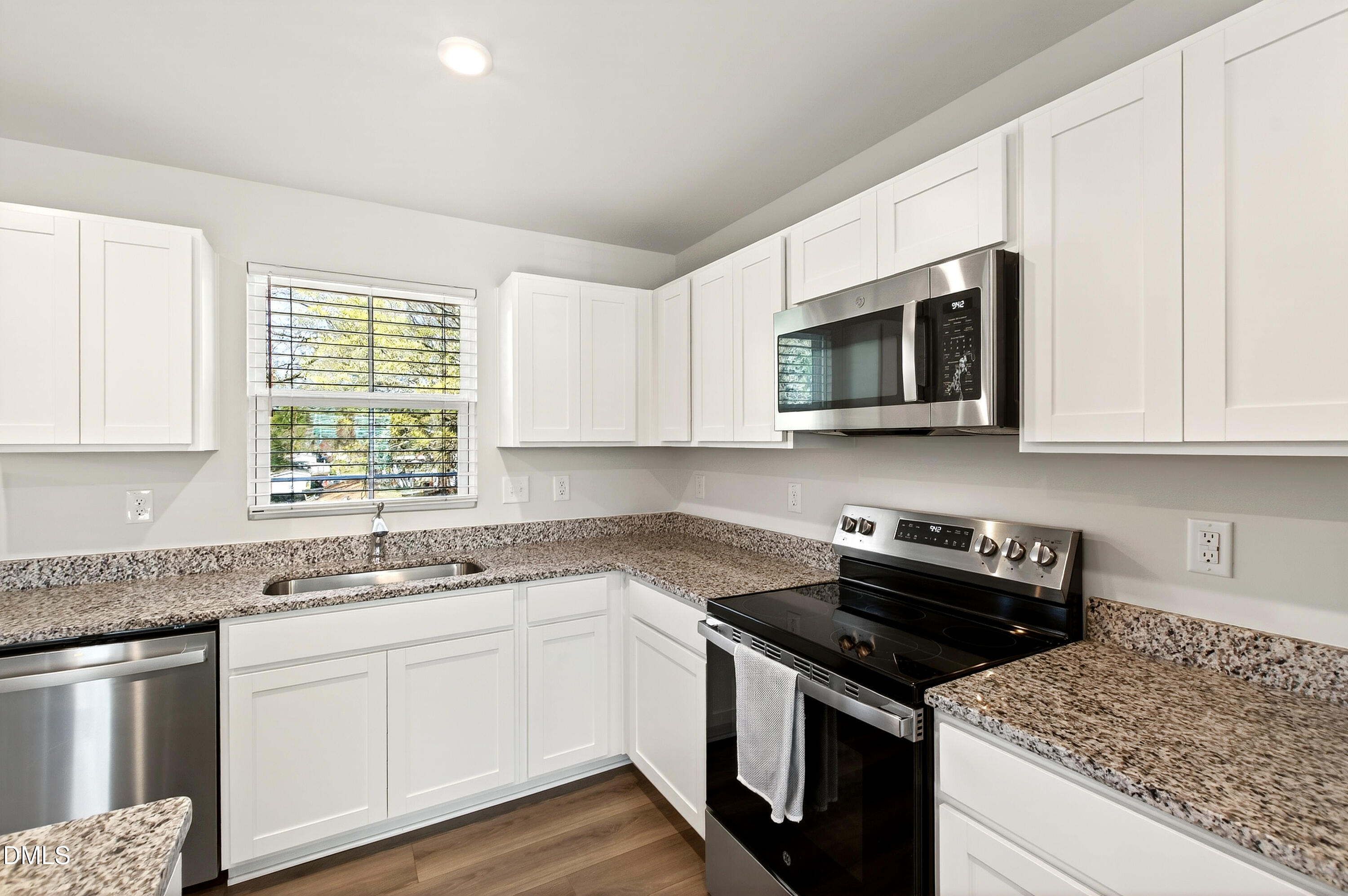4629 Great Egret Way Raleigh, NC 27616 - Photo 14 of 48 a kitchen with granite countertop white cabinets appliances a window and a sink