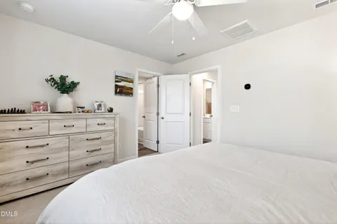a bedroom with a large bed and a dresser