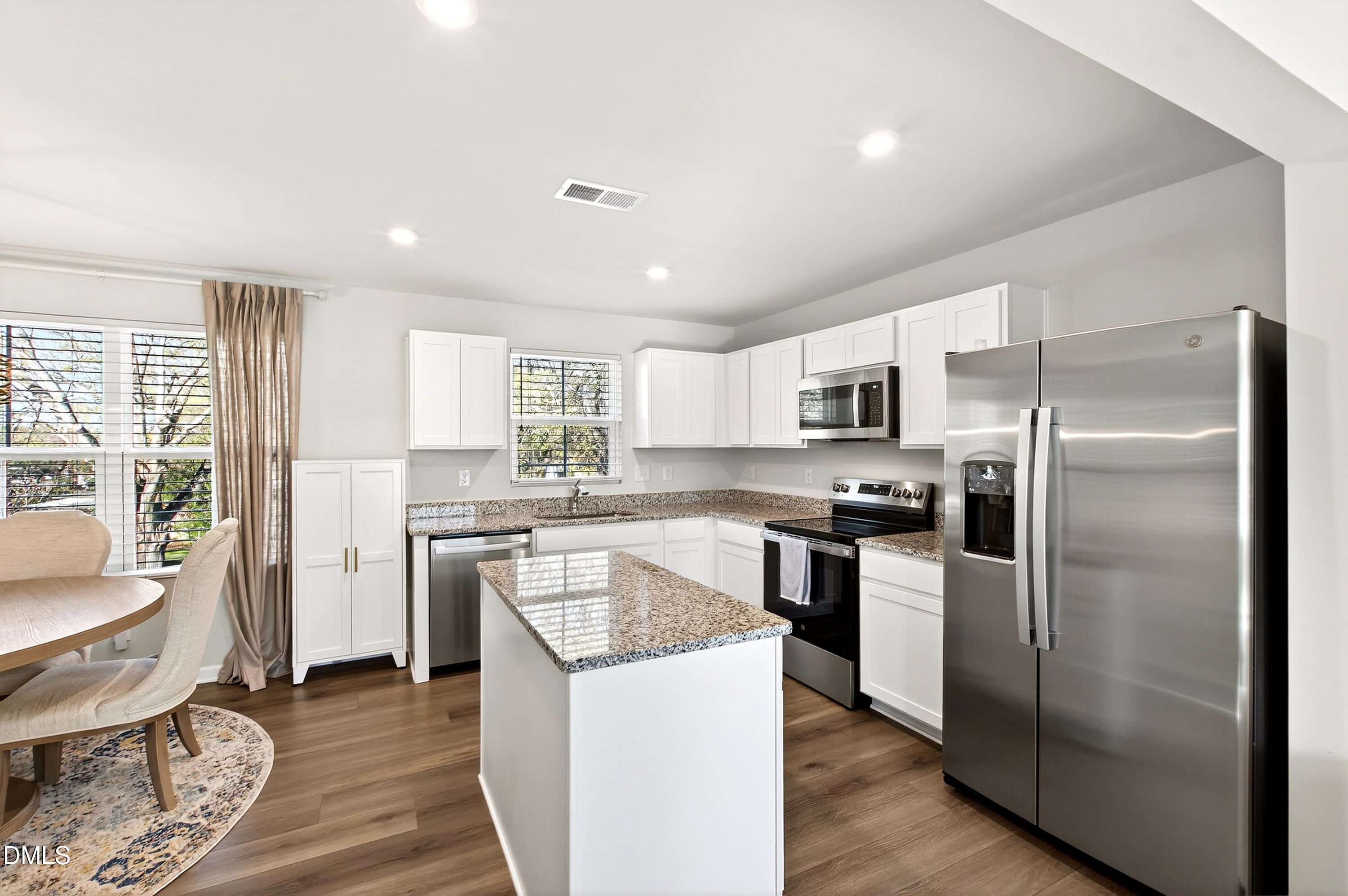 4629 Great Egret Way Raleigh, NC 27616 - Photo 2 of 48 a kitchen with a refrigerator a sink dishwasher with a dining table and chairs