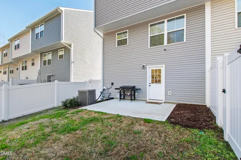 a backyard of a house with table and chairs