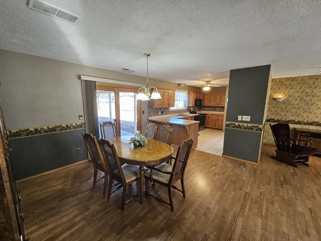 a view of a dining room with furniture and wooden floor