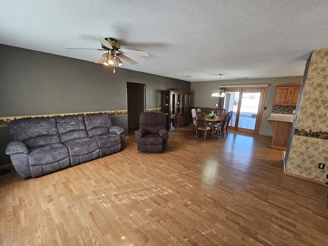 a living room with furniture dining table and a chandelier