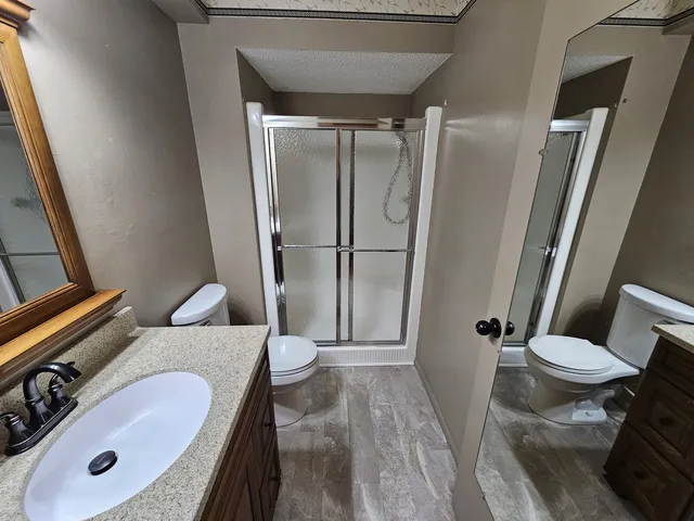 a bathroom with a sink toilet and shower