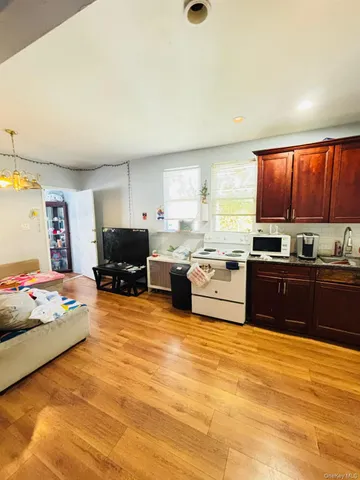 a kitchen with stainless steel appliances wooden cabinets and a refrigerator